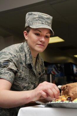 U.S. Air Force Airman 1st Class Amy Klavitzer, 509th Force Support Squadron food service apprentice, applies finishing touches to a Thanksgiving Day cake at the Ozark Inn on Whiteman Air Force Base, Mo., Nov. 28, 2013. The dining facility served a special Thanksgiving Day meal to increase morale among Airmen and families on base. (U.S. Air Force photo by Staff Sgt. Nick Wilson/Released)