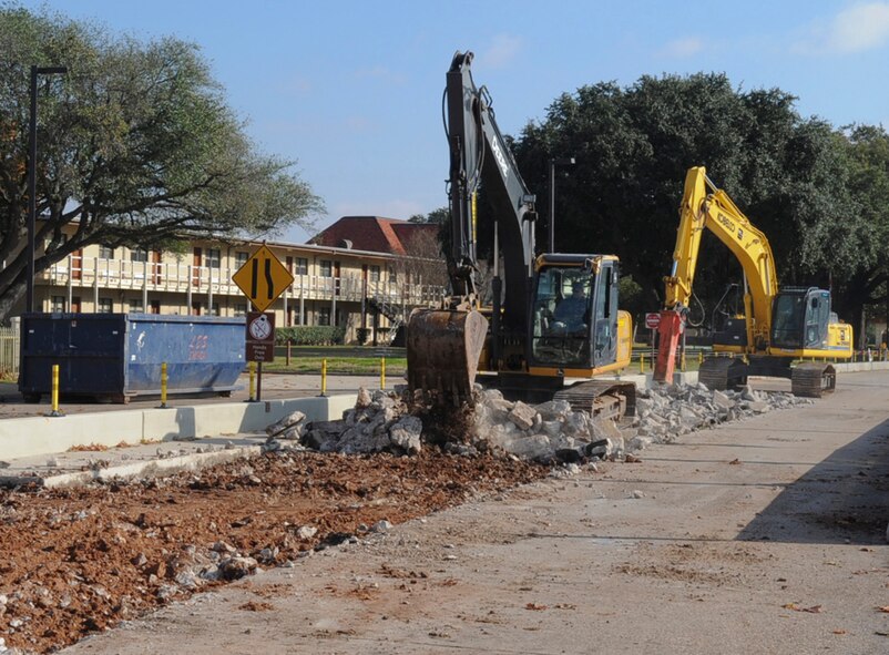 Staff Sgt. Nolan Strange, front, and Tech. Sgt. David Torres, 2nd Civil Engineer Squadron pavements and heavy equipment operators, use excavators to help begin construction on the Bossier Gate at Barksdale Air Force Base, La., Dec. 10, 2013. The gate will be receiving upgrades to improve base security and working conditions for 2nd Security Forces Defenders and is anticipated to open Spring of 2014. (U.S. Air Force photo/Senior Airman Kristin High)