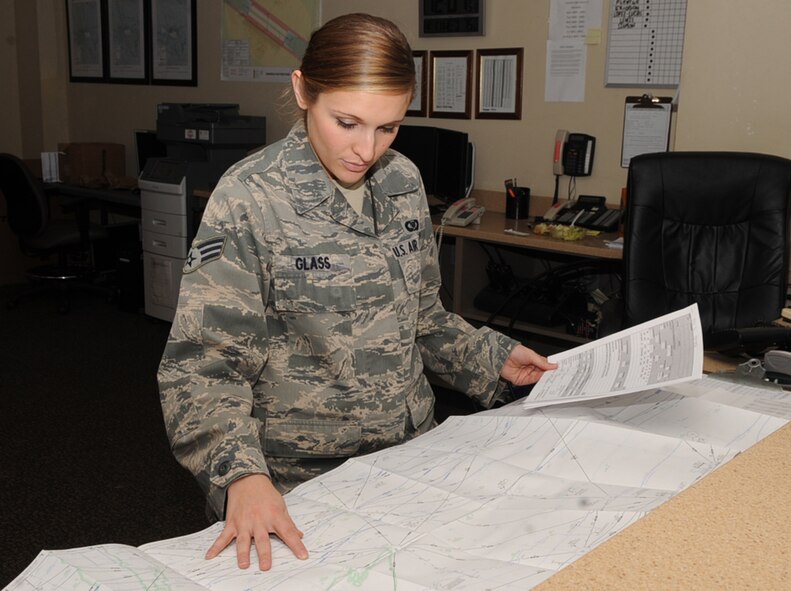 Senior Airman Meghan Glass, 2nd Operations Support Squadron airfield management, looks over flight maps and a flight plan on Barksdale Air Force Base, La., Dec. 11, 2013. Airfield management Airmen use this system to check and correct any errors in an aircraft?s flight plan. These flight plans are utilized in day-to-day operations as well as exercises and inspections to help complete the B-52H Stratofortress mission of Barksdale. (U.S. Air Force photo/Senior Airman Kristin High)