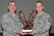 Senior Master Sgt. Daniel Anthony receives a statue from Col. Jay Pittman, 302nd Airlift Wing commander, during Pittman’s commander’s call Dec. 8 at Peterson Air Force Base, Colo. Anthony was recognized as the Air Force Reserve Command’s First Sergeant of the Year for 2012. (U.S. Air Force photo/Master Sgt. Daniel Butterfield)