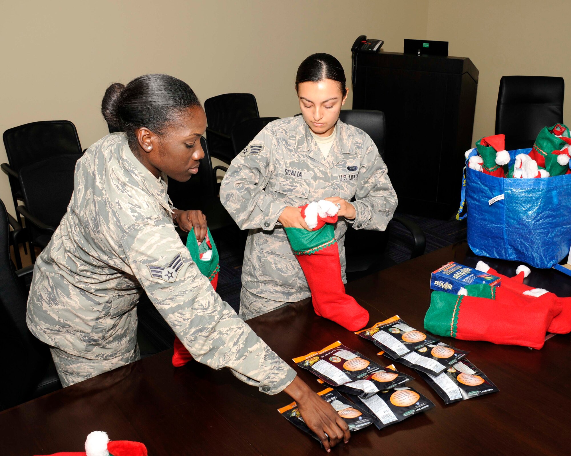 Senior Airman Rodane Williams, 482nd Fighter Wing Airman's Council president, and Senior Airman Marcela Scalia, council secretary, put together care packages for deployed members of the 482nd Maintenance Group on Dec. 11. The packages should arrive on Christmas Eve.