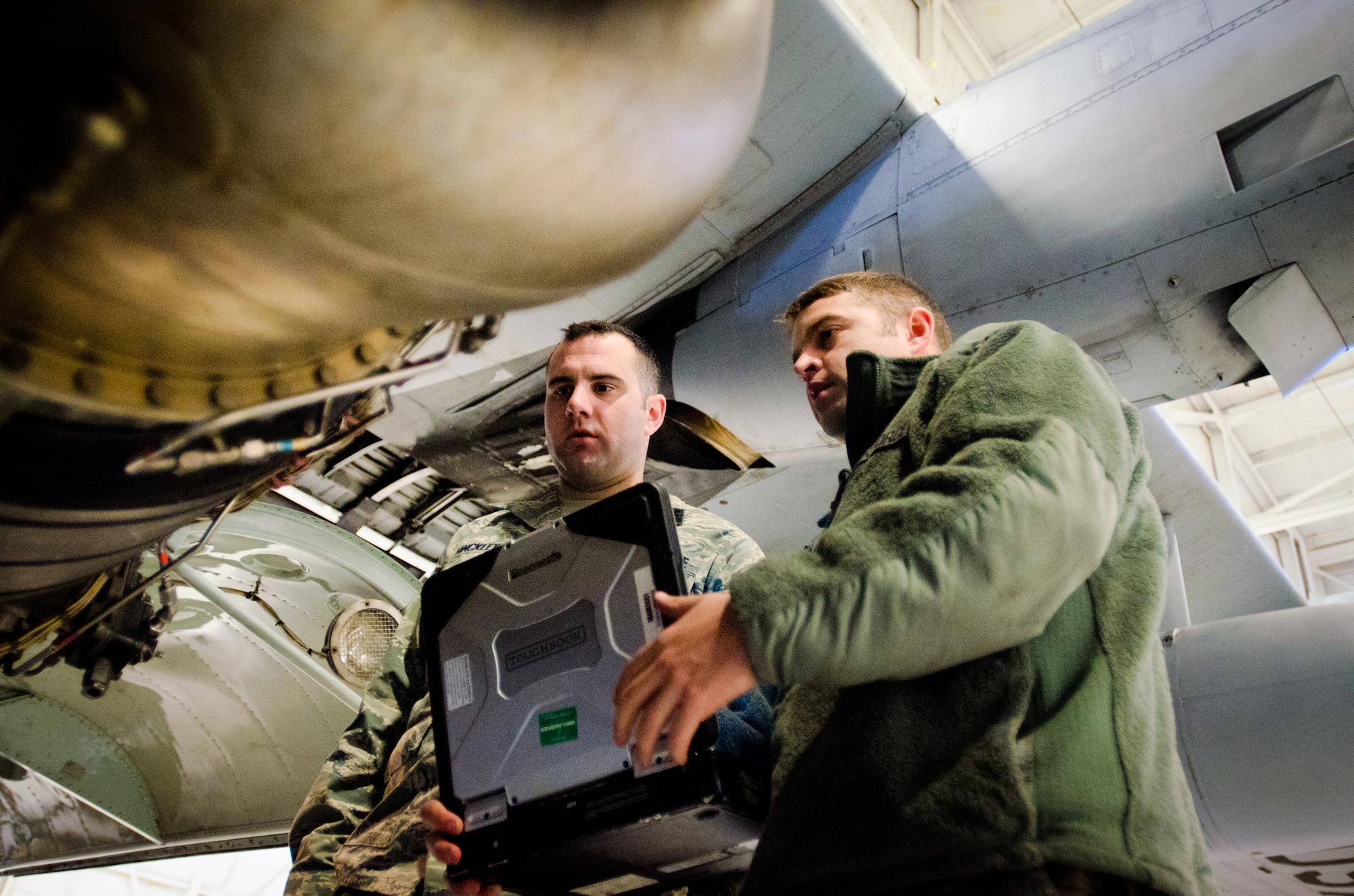 Tech. Sgt. Mike Johnson (right), a crew chief from the Kentucky Air National Guard's 123rd Aircraft Maintenance Squadron, shows Staff Sgt. Brian Hinckley, a crew chief from the Connecticut Air National Guard's 103rd Aircraft Maintenance Squadron, different maintenance aspects of the C-130 Hercules aircraft at the Kentucky Air National Guard base in Louisville, Ky., on Nov. 14, 2013. The Connecticut unit is converting from C-21A Learjets to the Hercules transport. (U.S. Air National Guard photo by Master Sgt. Phil Speck)