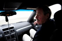Retired NASA astronaut Robert Gibson rides in a mobile chase car driven by Col. Phil Stewart, 9th Reconnaissance Wing commander, at Beale Air Force Base, Calif., Dec. 6, 2013. Stewart was escorting Gibson who was serving as a guest speaker at the wing holiday party.  (U.S. Air Force photo by Airman 1st Class Bobby Cummings/Released)