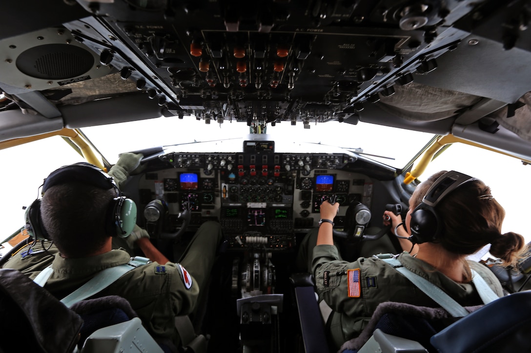 Pilots, Capts. Joel Webley, left, and Heather Combee, 108th Wing, New Jersey Air National Guard, intently fly a KC-135 Stratotanker during an air refueling mission of a C-17 Globemaster III Dec. 5, 2013. The aircrew consisted of pilots, Capts. Heather Combee, Johann Hintz and Joel Webley, as well as boom operators, Tech. Sgts. Jennifer Bowen and Patrick Ogle. The mission provided an opportunity for the the pilots and boom operators to hone their air-refueling skills aboard a KC-135 Stratotanker. (U.S. Air National Guard photo by Tech. Sgt. Armando Vasquez / Released)