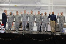U.S. Air Force Reserve Colonel James Dignan, 910th Airlift Wing commander, conducts the oath of enlistment for several Air Force Reserve re-enlistees, at the December commander’s call here, Dec. 7. (U.S. Air Force Photo/TSgt. Jim Brock)