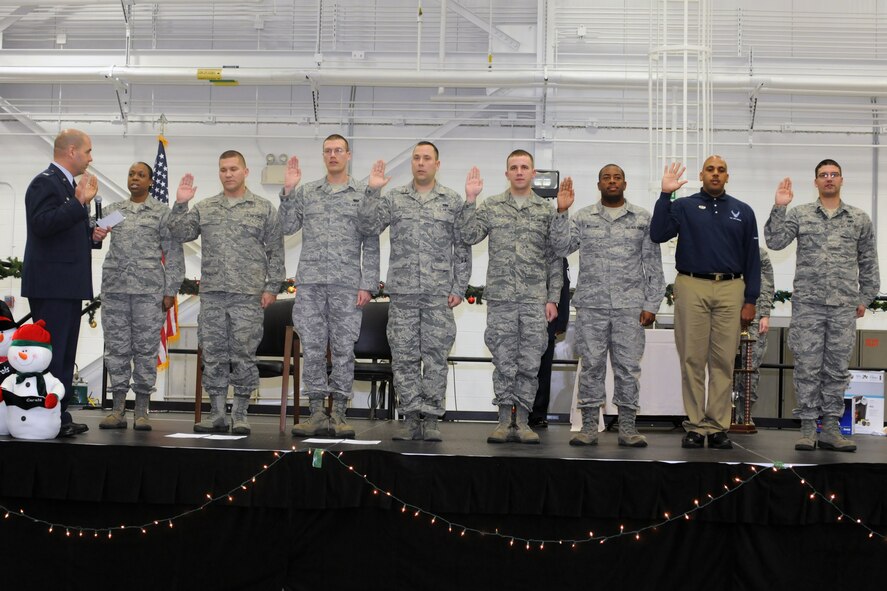 U.S. Air Force Reserve Colonel James Dignan, 910th Airlift Wing commander, conducts the oath of enlistment for several Air Force Reserve re-enlistees, at the December commander’s call here, Dec. 7. (U.S. Air Force Photo/TSgt. Jim Brock)