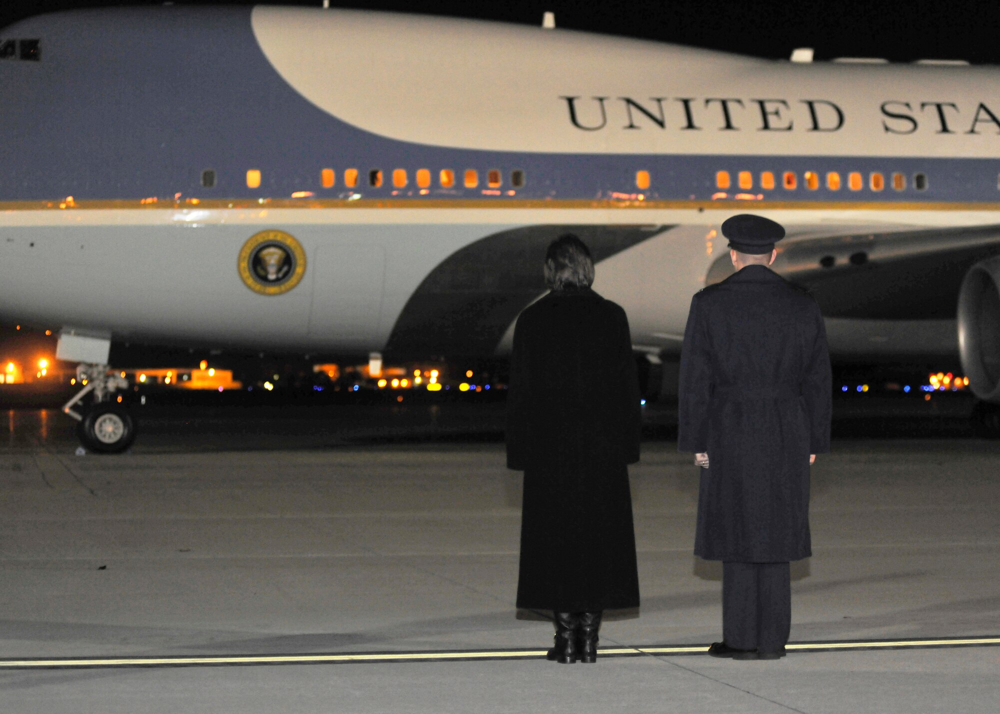 Col. Bill Knight, 11th Wing/Joint Base Andrews commander, and his wife Susan, wait to greet President Barack Obama and First Lady Michelle Obama Dec. 11, 2013. The President and first lady, along with former President George H.W. Bush and First Lady Laura Bush, were returning to the states after attending memorial services for former South African President, Dr. Nelson Mandela. (U.S. Air Force photo/Senior Airman Lindsey A. Porter)