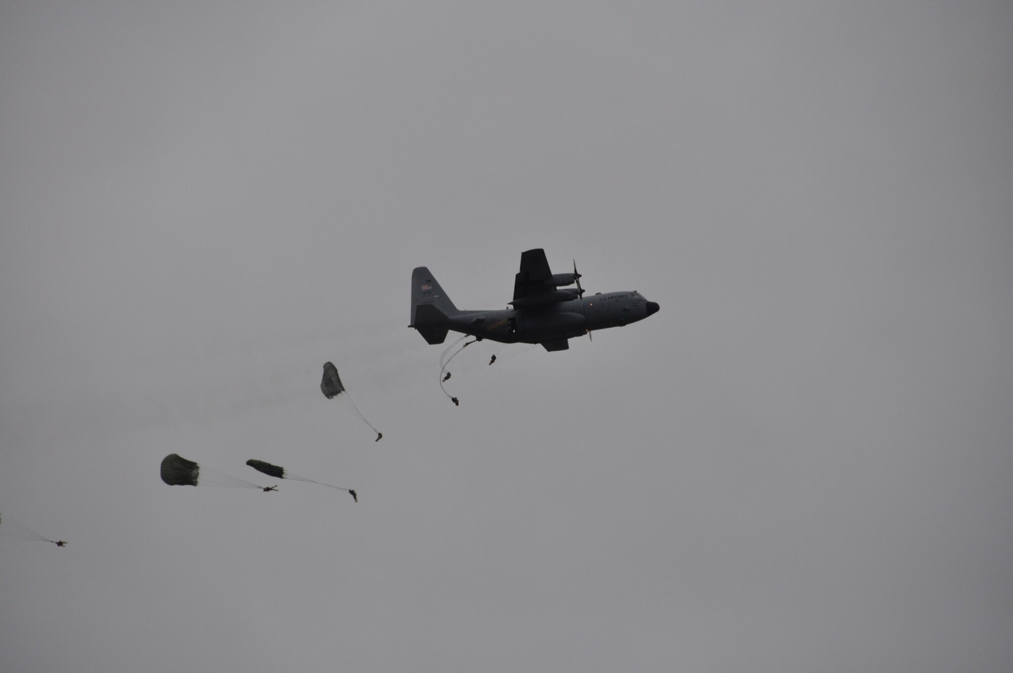 Army soldiers parachute from a C-130 in the skies over Sicily drop zone in participation of the 2013 Toy Drop at Fort Bragg, N.C., December 8th. Service members from across Fort Bragg donate a toy for charity in order to participate in an airborne jump to earn foreign wings. (U.S. Air Force photo by Tech. Sgt. Elizabeth Moody, 440th Airlift Wing Public Affairs)