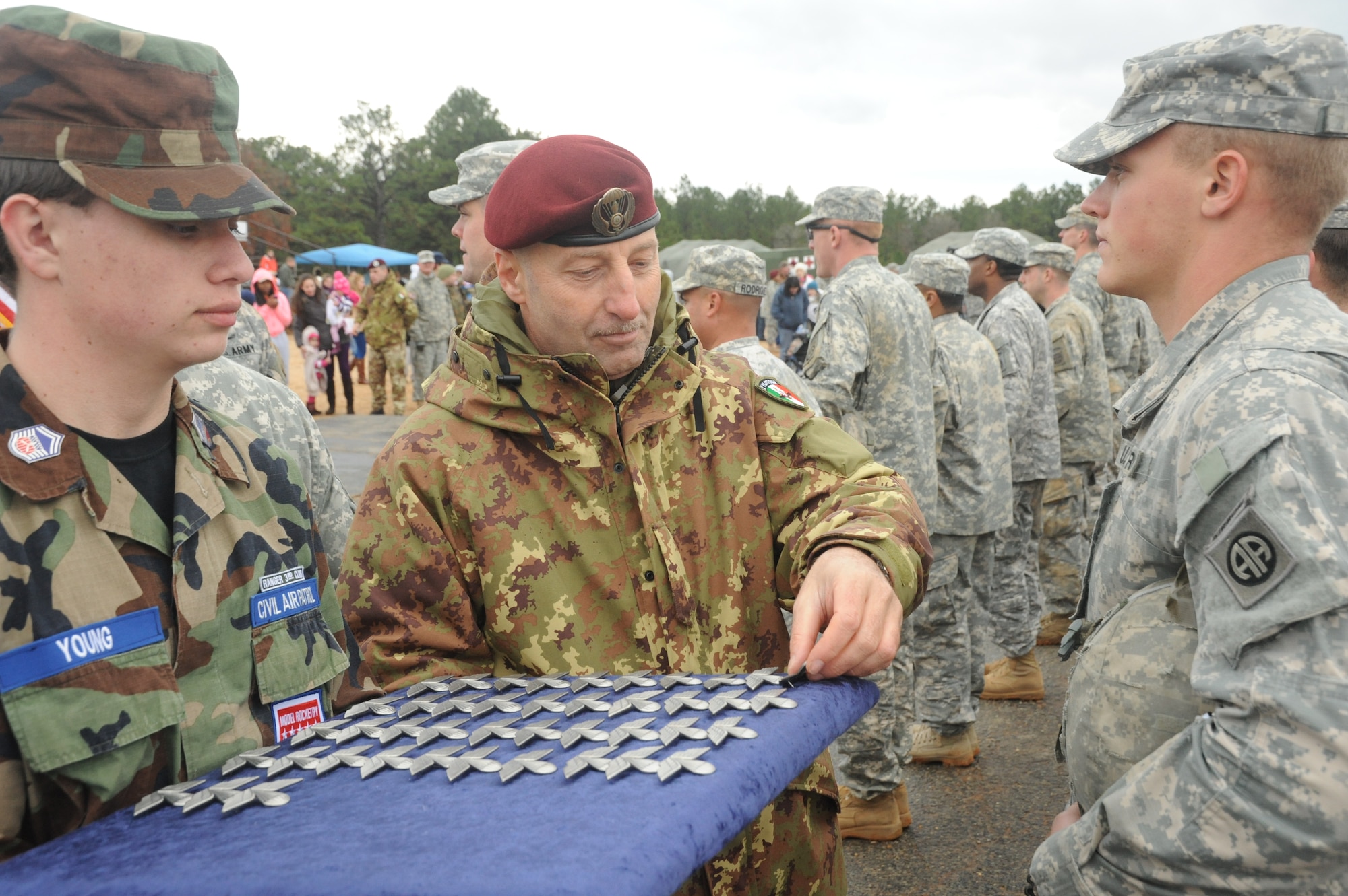 82nd Airborne Soldier receives foreign jump wings upon participation in the Toy Drop over Sicily drop zone at Fort Bragg, N.C., December 8, 2013. Service members from across Fort Bragg donate a toy for charity in order to participate in an Airborne jump to earn foreign wings. (U.S. Air Force photo by MSgt. Steven Steadler, 440th Airlift Wing Public Affairs)