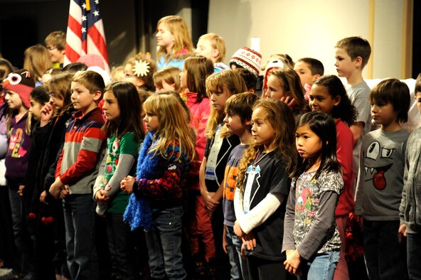Children from the Michael Andersen Elementary School sing carols during the base tree lighting Dec. 6, 2013, at Fairchild Air Force Base, Wash. The tree-lighting ceremony is an annual event held by Fairchild. (U.S. Air Force photo by Ryan Zeski/Released)