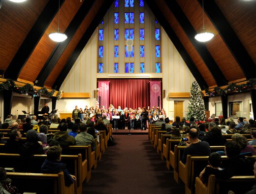 Children from the Michael Andersen Elementary School sing carols during the base tree lighting Dec. 6, 2013, at Fairchild Air Force Base, Wash. The tree-lighting ceremony is an annual event held by Fairchild. (U.S. Air Force photo by Ryan Zeski/Released)