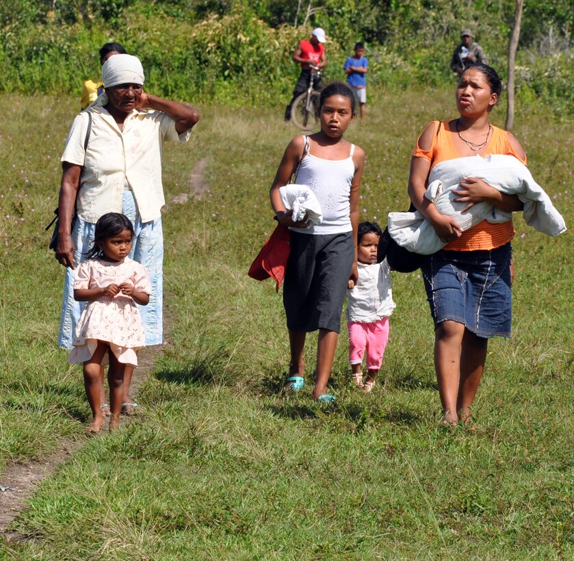 A group of Honduran citizens make their way along a path to receive medical care at a Medical Readiness Training Exercise (MEDRETE) conducted by Joint Task Force-Bravo in the Department of Gracias a Dios, Honduras, Dec. 4, 2013.  Joint Task Force-Bravo routinely partners with the Honduran Ministry of Health and the Honduran military to perform these humanitarian aid missions to provide medical care to the most isolated regions of the country. (U.S. Air Force photo by Capt. Zach Anderson)