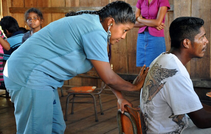 Dr. Yuki Pravia Navas, a Honduran doctor of general medicine, examines a patient during a Medical Readiness Training Exercise (MEDRETE) conducted by Joint Task Force-Bravo in the Department of Gracias a Dios, Honduras, Dec. 4, 2013.  Joint Task Force-Bravo routinely partners with the Honduran Ministry of Health and the Honduran military to perform these humanitarian aid missions to provide medical care to the most isolated regions of the country. (U.S. Air Force photo by Capt. Zach Anderson)