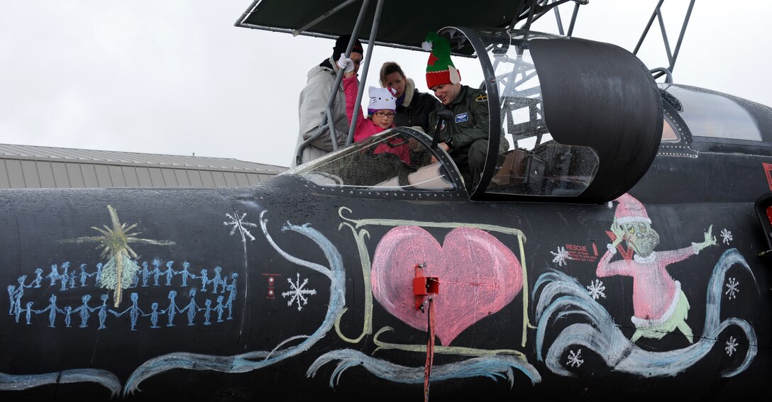 A U-2 Dragon Lady pilot leads a static display tour during Beale’s annual Children’s Holiday Party at Dec. 7, 2013. More than 500 military families attended. (U.S. Air Force photo by Staff Sgt. Robert M. Trujillo/Released)