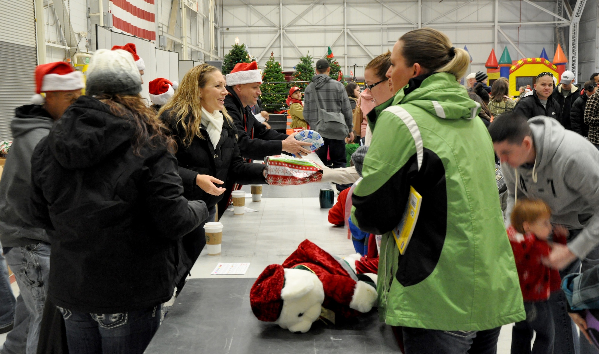 Volunteers of Team Beale hand out more than 2,000 gifts to military families during Beale’s annual Children’s Holiday Party Dec. 7, 2013. The gifts were donated by Toys for the Troops, a non-profit organization that provides holiday toys to children of overseas/deployed military members. (U.S. Air Force photo by Staff Sgt. Robert M. Trujillo/Released)