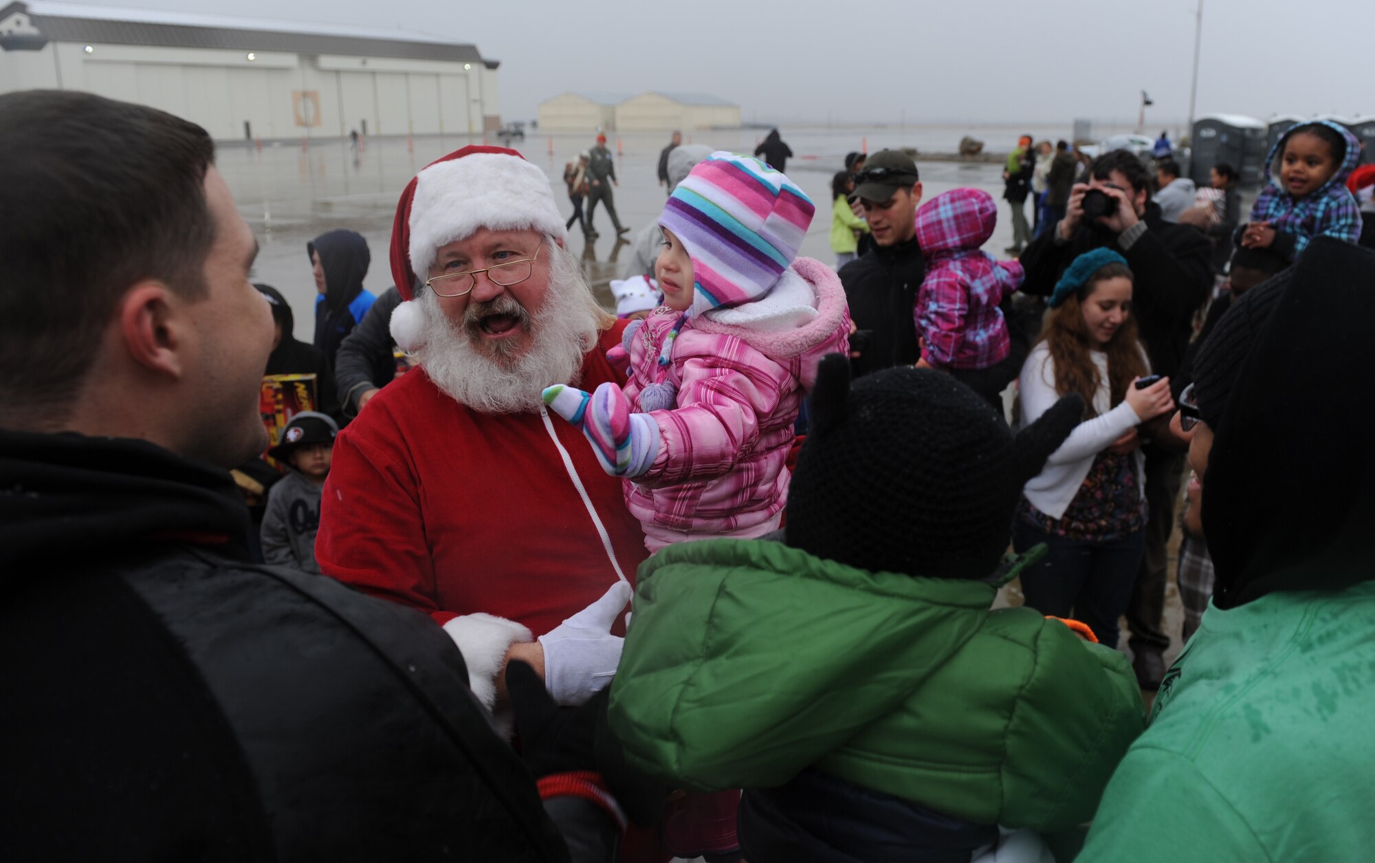 Santa Claus greets children during Beale’s annual Children’s Holiday Party at Dock 6 Dec. 7, 2013. Santa posed with children for commemorative photos and handed out more than 2,000 toys donated to the base by Toys for the Troops. (U.S. Air Force photo by Staff Sgt. Robert M. Trujillo/Released)