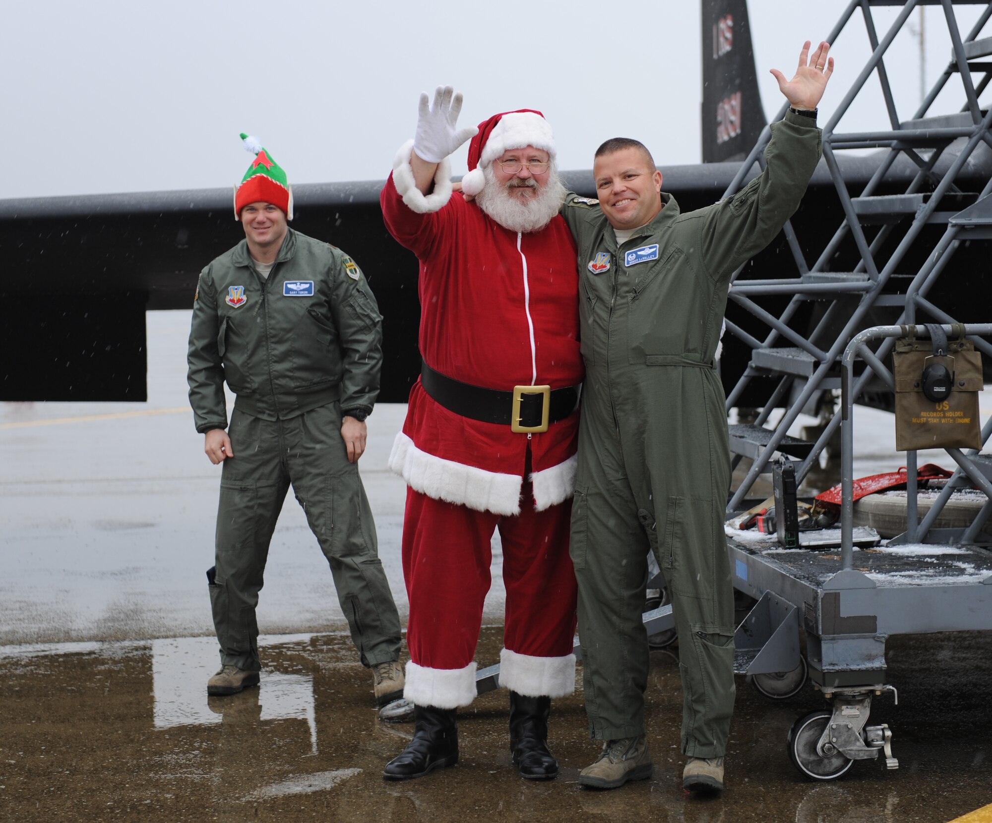 Santa Claus and Lt. Col. Mikko LaValley, 99th Reconnaissance Squadron commander, greet more than 500 military families during Beale’s annual Children’s Holiday Party Dec. 7, 2013. Santa’s elves arrived at the event on a MC-12 Liberty and the Grinch via a fire truck. (U.S. Air Force photo by Staff Sgt. Robert M. Trujillo/Released)
