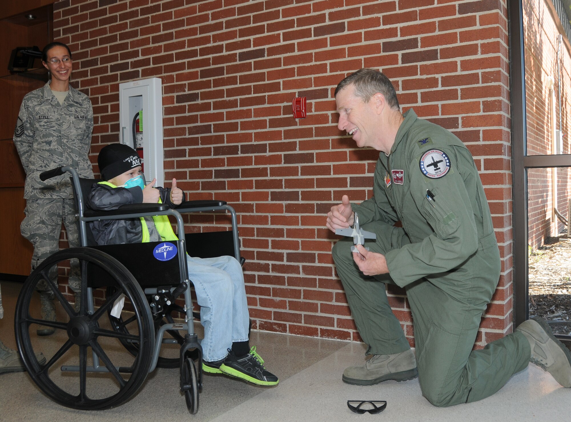 Pilot for a day Skyler Leroy presents 188th Fighter Wing commander Col. Mark Anderson with an A-10 model he built for the occasion. (U.S. Air National Guard photo by Senior Airman John Hillier/188th Fighter Wing Public Affairs)