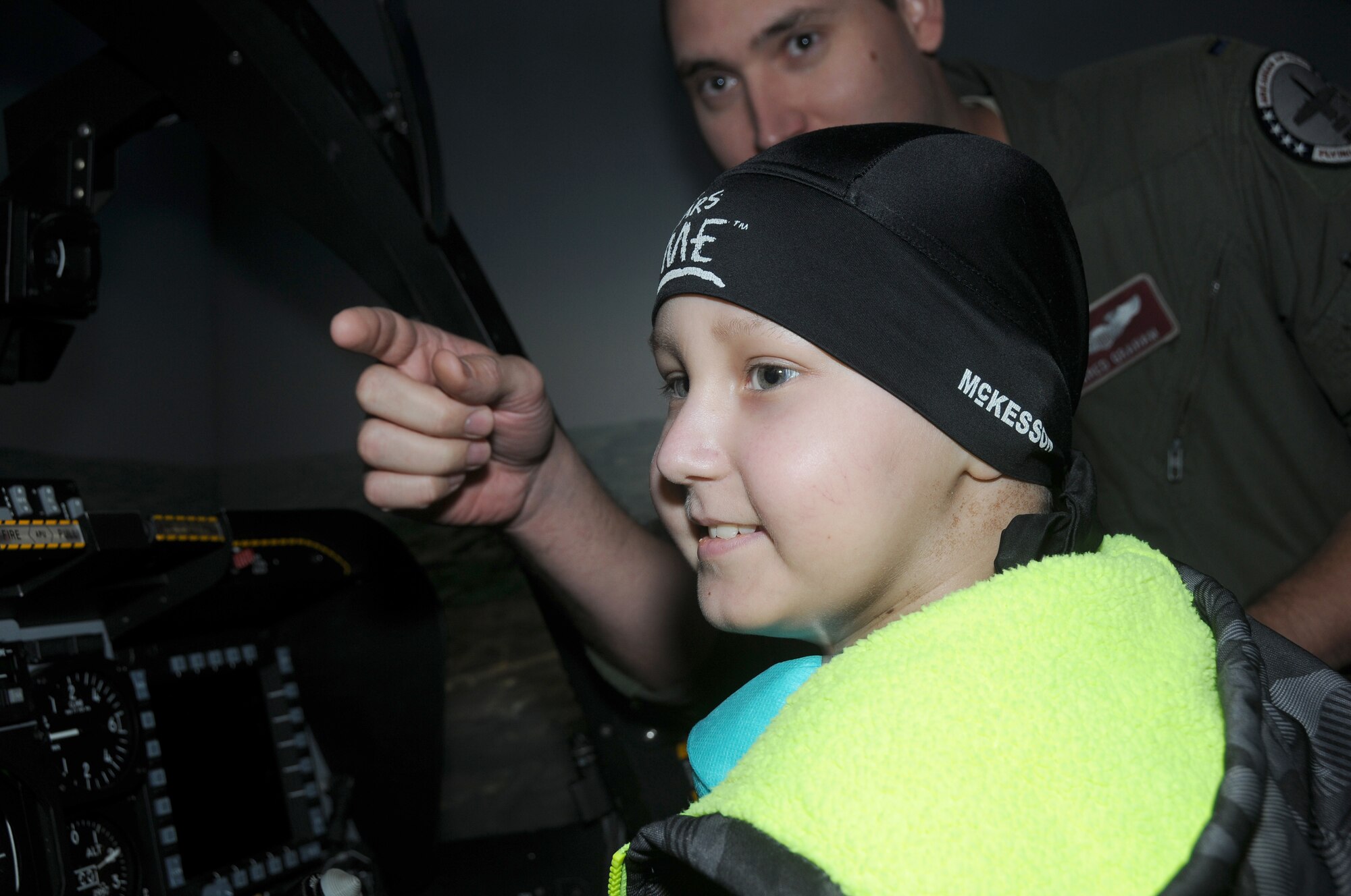 1st Lt. Jared Graham, A-10 pilot with the 184th Fighter Squadron, gives pilot for a day Skyler Leroy a guided tour of the 188th's A-10 simulator. Leroy took a flight in the simulator and engaged in a dogfight above the virtual skies of Fort Smith, Ark. (U.S. Air National Guard photo by Senior Airman John Hillier/188th Fighter Wing Public Affairs)
