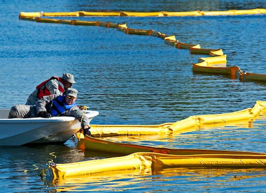 Volunteers position a 500 feet stretch of oil boom to be installed in Weekly Bayou on Eglin Air Force Base, Fla., in a recent waterways oil spill exercise. Boom is an oil containment device used to trap oil in the water so it can be collected before reaching the shore. A collection of emergency responders from more than 15 Eglin units will deploy to Weekly Bayou, Dec. 13, to participate in an oil spill response exercise. The annual exercise is required by federal and state regulations governing Inland Coastal Oil Spill Response for the Eglin AFB Marine Fuel Transfer Facility.  This year’s exercise will take place in the Weekly Bayou from 7:30 a.m. until noon.  The Post'l Point Boat Launch Ramp will be closed to the public during these hours, however the Eglin Yacht Club boat launch ramp will be open to boaters during this time due to emergency response vehicles operating in that area. (U.S. Air Force photo/Samuel King Jr.)