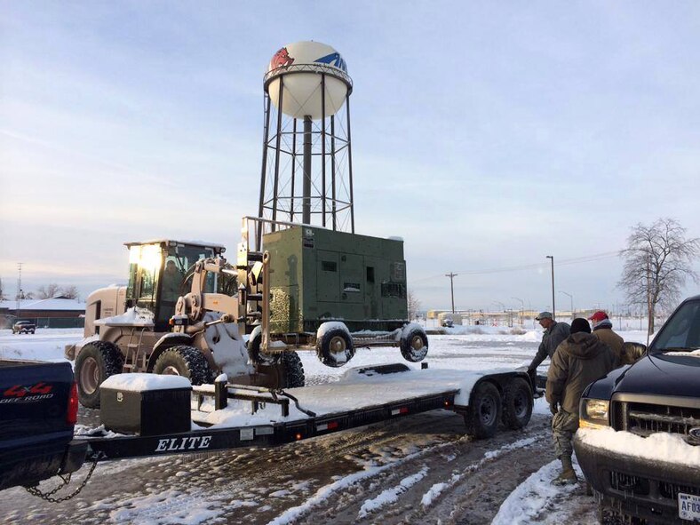 The 188th answers the call: Members of the 188th Fighter Wing load equipment on a flatbed trailer Dec. 8, 2013. The 188th was tasked by the state to provide generator support to Cass, Ark., in response to winter weather events that affected much of Arkansas Dec. 5-9. (Photo by Chief Master Sgt. Ron Redding/188th Fighter Wing)