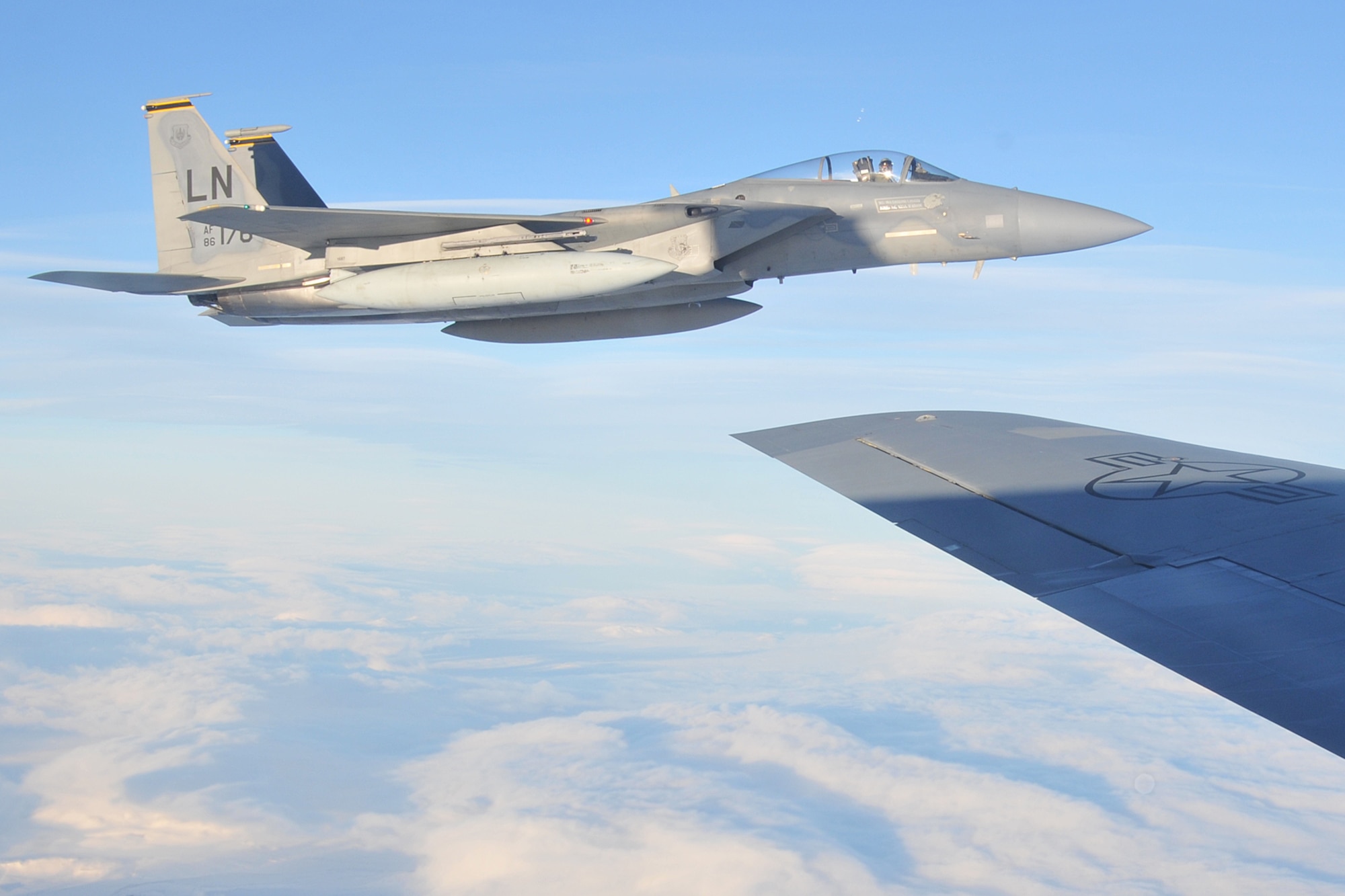 An F-15C Eagle, deployed from Royal Air Force Lakenheath, England, performs a mock aerial interception on a KC-135 Stratotanker, deployed from RAF Mildenhall, England, while flying over Iceland Nov. 21, 2013. The 48th Air Expeditionary Group maintained the NATO air surveillance and policing mission in Iceland from Oct. 28 to Nov. 29. (U.S. Air Force photo by 1st Lt. Leah Davis/Released)