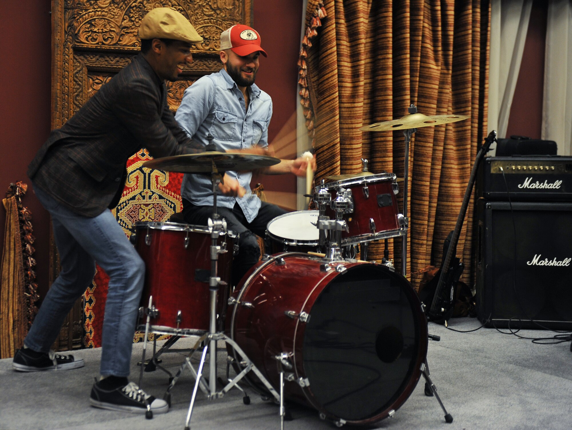 Jonathan Batiste plays the drums with Joe Saylor, drummer,  during the Stay Human Band performance  for service members at the 379th Air Expeditionary Wing, Southwest Asia, on Dec. 8, 2013. The band played modern jazz at the Kasbah which is one of the entertainment venues here. (U.S. Air Force photo/Master Sgt. David Miller)