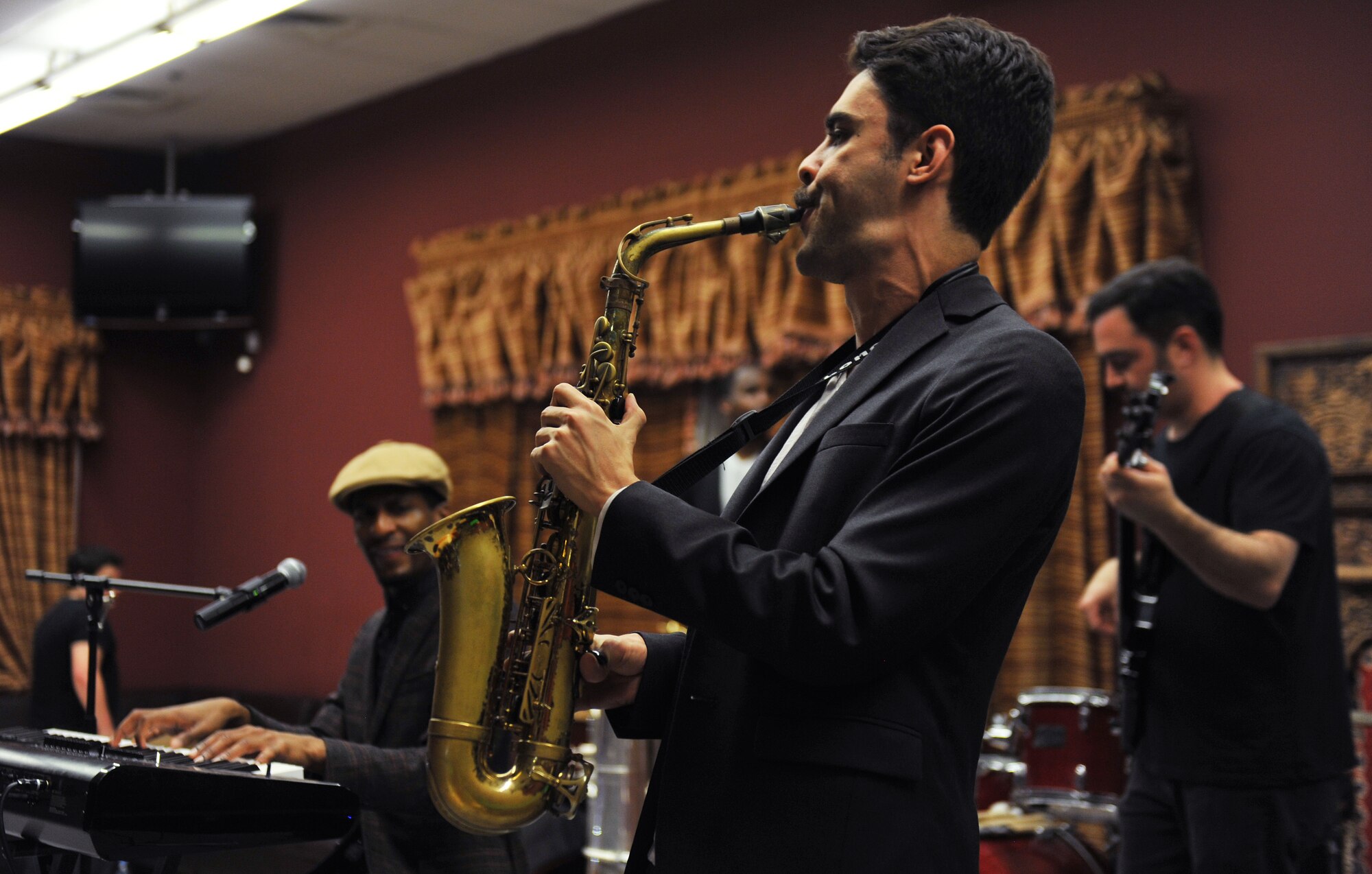 Eddie Barbash plays the alto saxophone during the Jonathan Batiste and the Stay Human Band performance at the 379th Air Expeditionary Wing, Southwest Asia, on Dec. 8, 2013. The band played modern jazz for service members at the Kasbah which is one of the entertainment venues here. (U.S. Air Force photo/Master Sgt. David Miller)