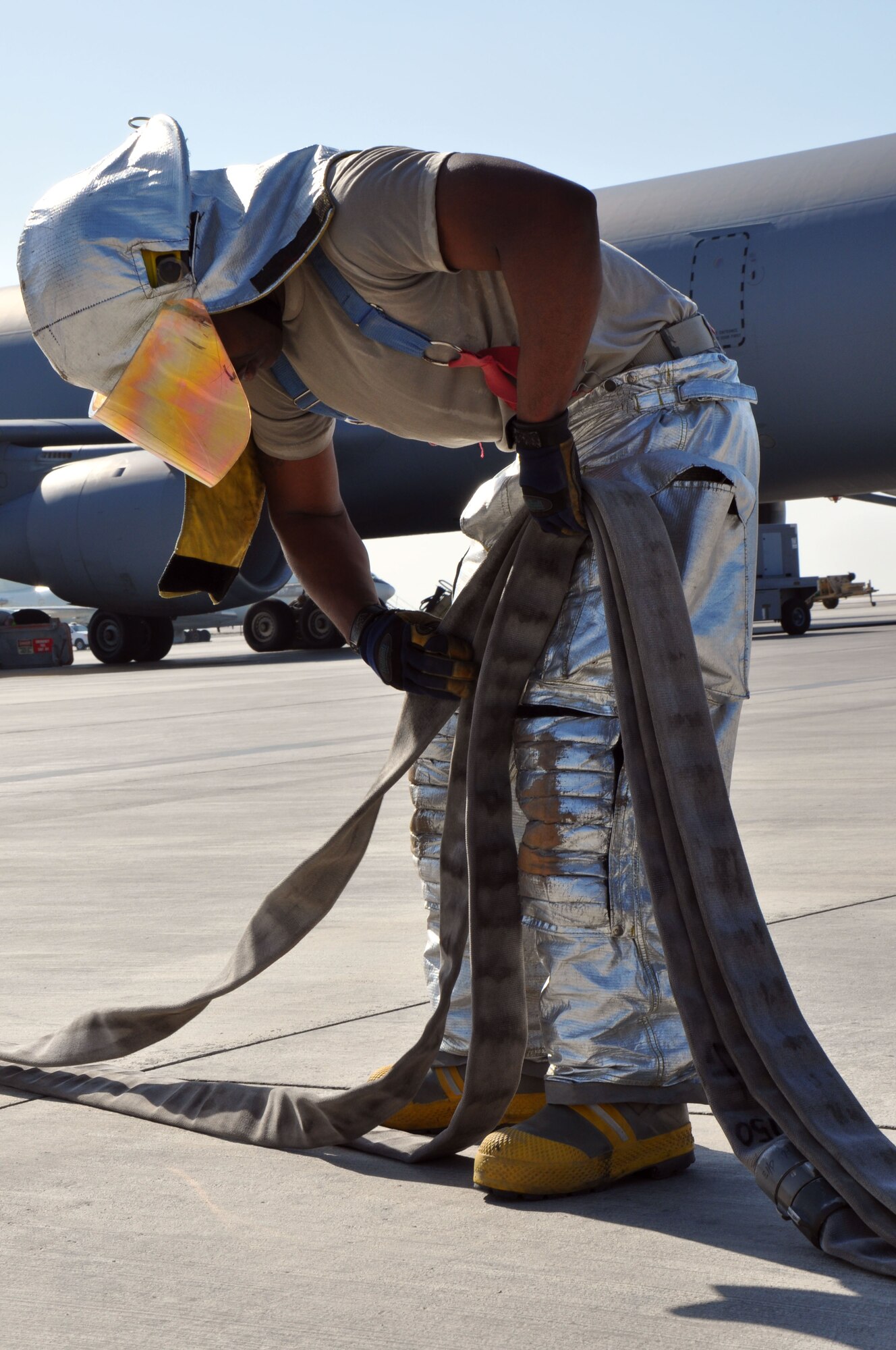 Senior Airman Jermaine Arzu, a crew chief assigned to the 380th Expeditionary Civil Engineer Squadron here, loads a triple layer handline back into the compartment of his truck to help get the truck back in service after a training exercise here Dec. 10, 2013. Arzu is originally from Los Angeles, Calif., and deployed here from Davis-Monthan Air Force Base, Ariz. (U.S. Air Force photo by Master Sgt. April Lapetoda/Released)