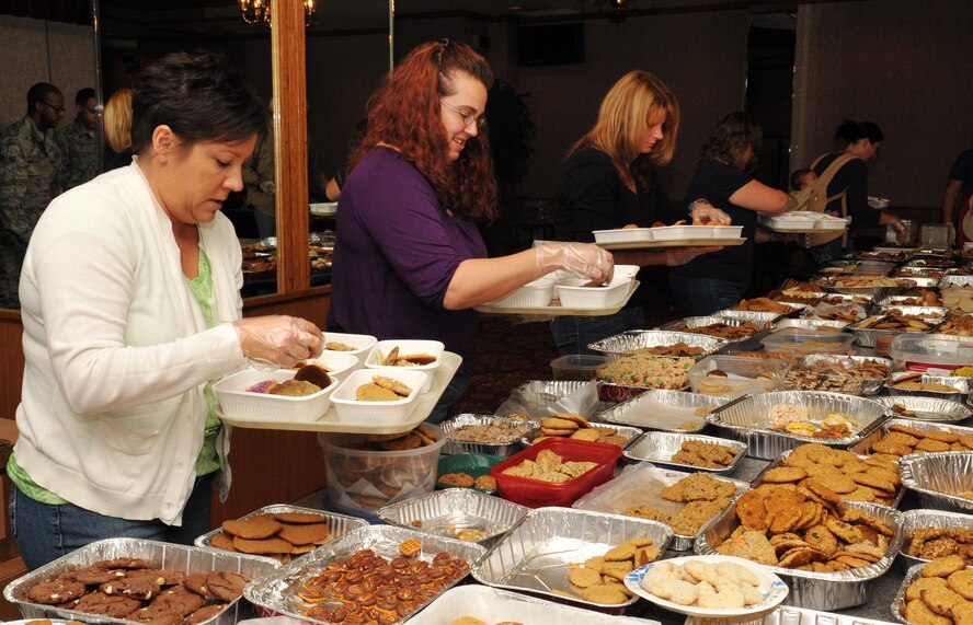 Team Kadena spouse volunteers place cookies in trays during the place cookies in trays during the 2013 Team Kadena Cookie Drive on Kadena Air Base, Japan, Dec. 11, 2013. This annual event was hosted by the First Sergeants Association and the Okinawa Enlisted Spouse Club. The OESC donated all the funds for the packaging and advertising for the cookie drive. (U.S. Air Force photo by Naoto Anazawa)