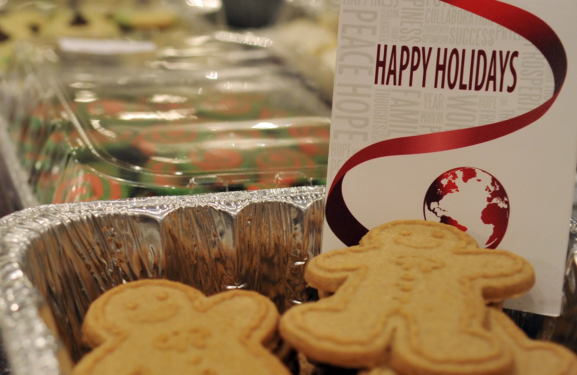 Approximately 33,000 cookies were baked by volunteers from Kadena Air Base during the 2013 Team Kadena Cookie Drive on Kadena Air Base, Japan, Dec. 11, 2013. The cookie drive for single, dorm residing service members is just one of many traditions observed at Kadena Air Base during the holiday season. Each wrapped container of cookies was topped with a holiday card designed by the American Red Cross stationed on Kadena. (U.S. Air Force photo by Naoto Anazawa) 