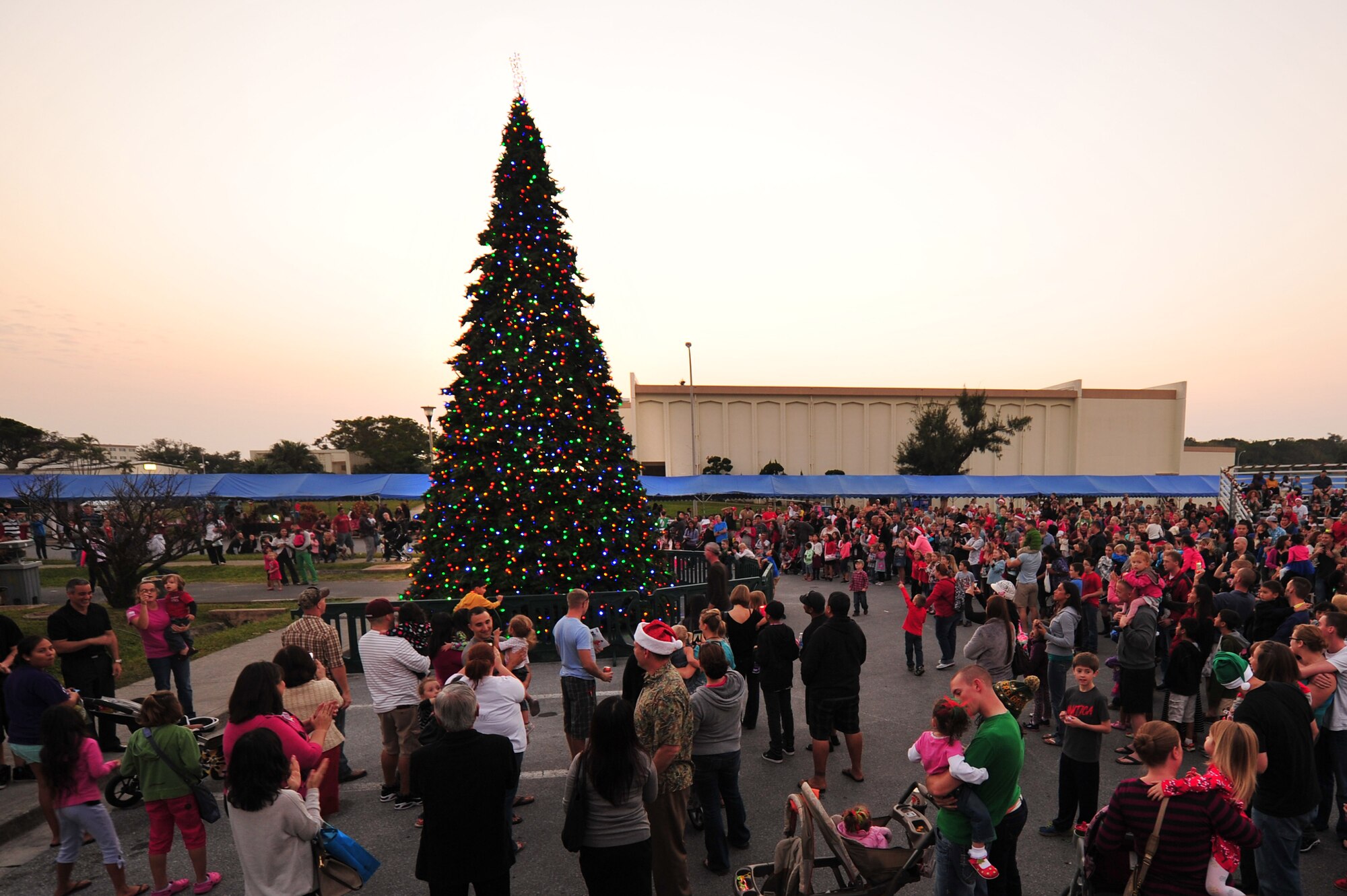 Families gather around Team Kadena's Christmas tree for the tree lighting ceremony on Kadena Air Base, Japan, Dec. 7, 2013. The tree lighting event was the last event of the annual Tinsel Town event for service members and their families. (U.S. Air Force photo by Staff Sgt. Rachelle Coleman)