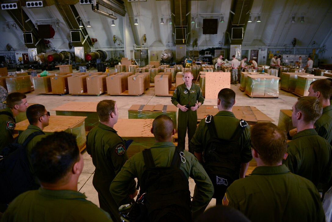 Capt. Olin Johnson, 36th Airlift Squadron, briefs fellow aircrew members at Andersen Air Force Base, Guam, during Operation Christmas Drop, Dec. 9, 2013. This year marks the 62nd year of Operation Christmas Drop, which began in 1952, making it the world's longest running airdrop mission. Every December, C-130 Hercules crews from the 374th Airlift Wing at Yokota Air Base, Japan, partner with the 36th Wing at Andersen Air Force Base, Guam, to airlift food, supplies and toys to islanders throughout Micronesia. (U.S. Air Force photo by 2nd Lt. Jake Bailey/Released)