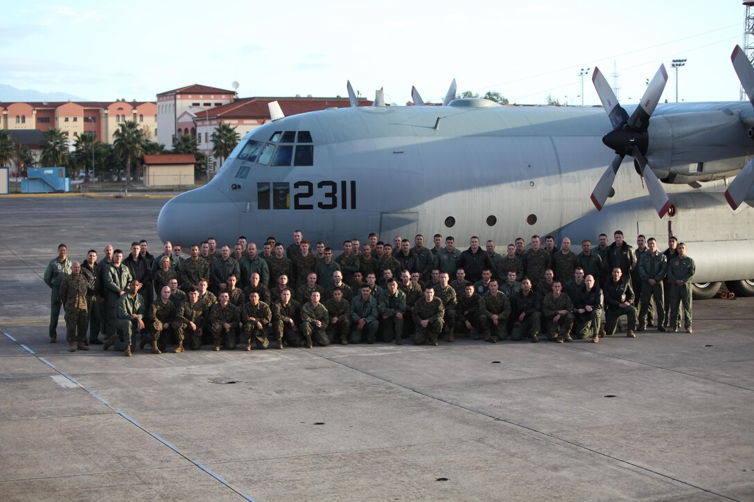 U.S. Marines from Marine Aerial Refueler Transport Squadron 234 (VMGR-234) pose for a photo in front of a KC-130T Nov. 12, 2013, aboard Naval Air Station Sigonella, Italy. The Marines of VMGR-234 rotated detachments in support of Special-Purpose Marine Air-Ground Task Force Africa 13. 
