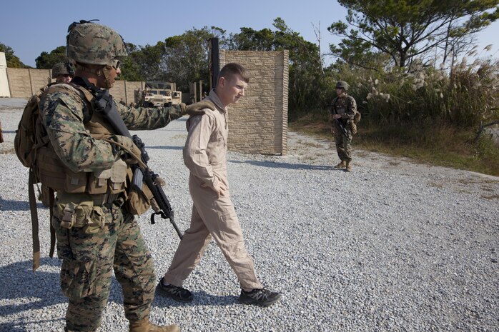 Marines escort a downed pilot role-player they located Dec. 5 amid a tactical recovery of aircraft and personnel scenario during Exercise Chromite. During the exercise, Marines gained valuable experience, which will prepare them to succeed in real-world operations. The Marines are with Weapons Company, 3rd Battalion, 1st Marine Regiment, currently assigned to 4th Marines, 3rd Marine Division, III Marine Expeditionary Force, under the unit deployment program.

