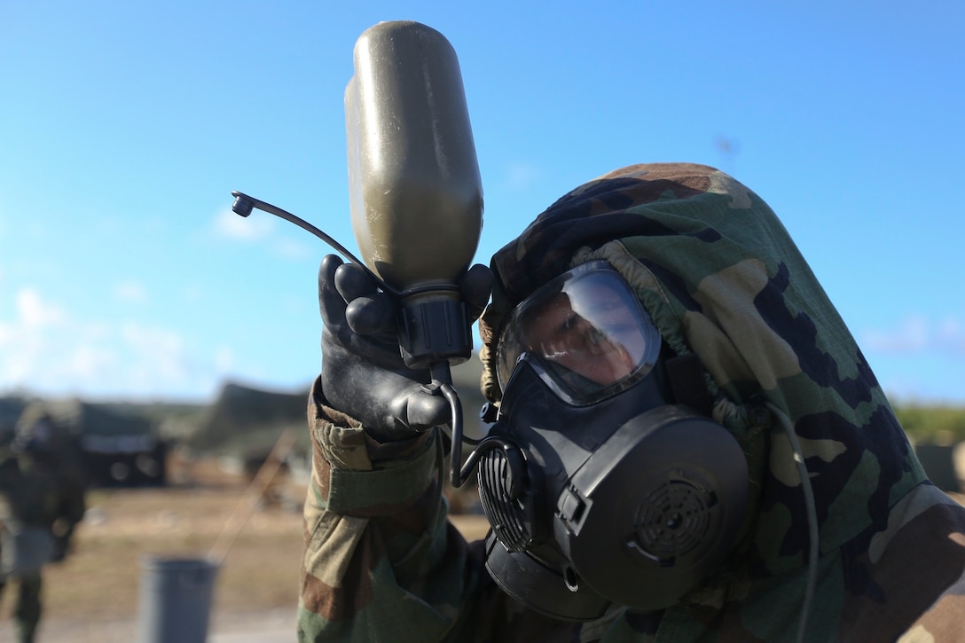 A Marine drinks water from a canteen during chemical, biological, radiological, nuclear defense training exercise on North Field, Tinian, Northern Mariana Islands during exerciser Forager Fury II, Dec. 3, 2013. This CBRND exercise is used to train Marines on the procedures of how to act and react in a contaminated environment. The Marine is with with Marine Aircraft Group 12, 1st Marine Aircraft Wing, III Marine Expeditionary Force. (U.S. Marine Corps photo by Lance Cpl. Austin Schlosser/Released)

