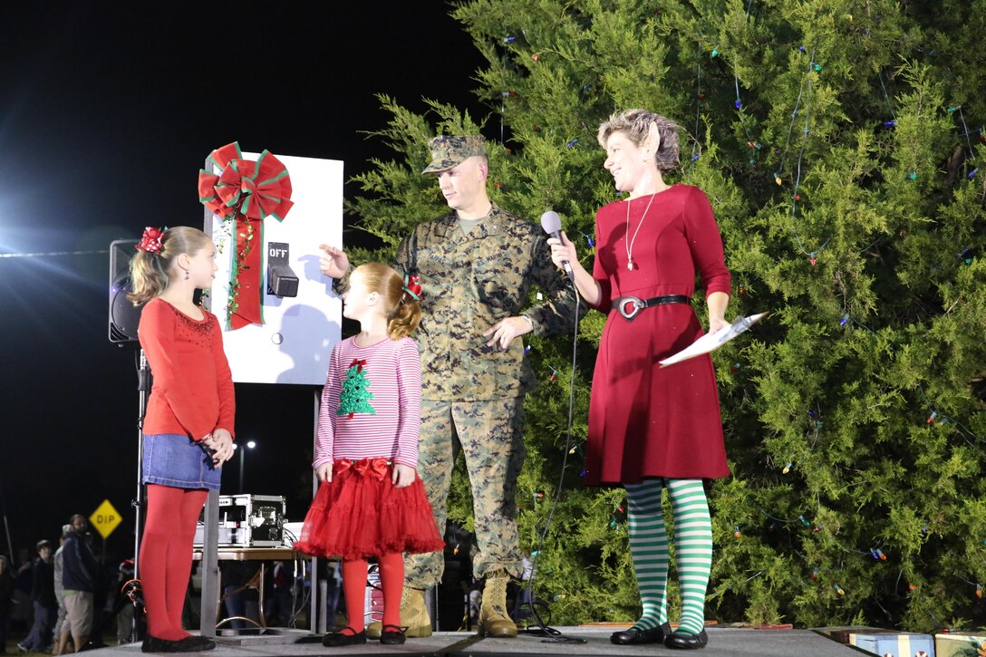 Col. Chris Pappas III and the daughters of Gunnery Sgt. Jeffery D. Bean prepare to flip a switch to light the Marine Corps Air Station Cherry Point Christmas tree during the 14th annual Christmas tree lighting at the Marine Corps Exchange Dec. 4. The tree lighting brought Marines, sailors and their families together to mark the start of the holiday season with a showing of "Frosty the Snowman," refreshments and an appearance by Saint Nicholas. Pappas is the commanding officer of Marine Corps Air Station Cherry Point