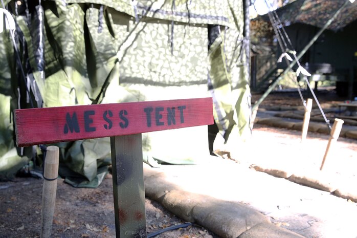 A sign is posted in front of the mess tent to mark all of the tents for the food service specialists with Food Service Company, Combat Logistics Regiment 27, 2nd Marine Logistics Group to prepare food for the Maj. Gen. W.P.T. Hill Field Mess Competition aboard Camp Lejeune, N.C., Dec. 11, 2013. In addition to the competition, the company came out to feed the surrounding units in the field with hot meals in support of their training evolution. 