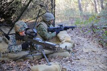Marines with Food Service Company, Combat Logistics Regiment 27, 2nd Marine Logistics Group provide security for the food service specialists to prepare their meal for the Maj. Gen. W.P.T. Hill Field Mess Competition aboard Camp Lejeune, N.C., Dec. 11, 2013. The Food Service Co. Marines prepared shrimp jambalaya, chicken creole, rice, cornbread, oatmeal cookies, corn, brownies, fruit cocktail, salad along with juices and coffee to drink. 