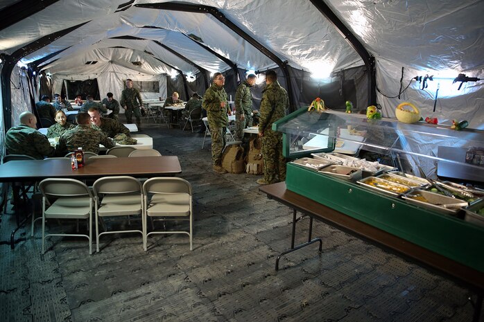 Marines from various units eat a hot meal prepared by food service specialists with Food Service Company, Combat Logistics Regiment 27, 2nd Marine Logistics Group aboard Camp Lejeune, N.C., Dec. 11, 2013. Food Service Co. prepared meals that were judged for the Maj. Gen. W.P.T. Hill Field Mess Competition. 

