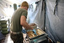 A food service specialist with Food Service Company, Combat Logistics Regiment 27, 2nd Marine Logistics Group prepares cookies for the Maj. Gen. W.P.T. Hill Field Mess Competition aboard Camp Lejeune, N.C., Dec. 11, 2013. The Food Service Co. Marines prepared shrimp jambalaya, chicken creole, rice, cornbread, oatmeal cookies, corn, brownies, fruit cocktail and salad, along with juices and coffee to drink. 