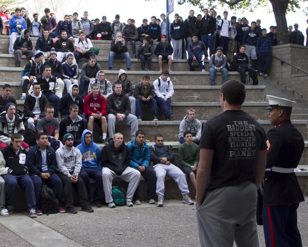SAN JOSE – U.S. Marine Sgt. Enasio Alston, a recruiter from Recruiting Sub-Station San Jose North, presents a Semper Fidelis All-American Football Bowl jersey to Kyle Carta-Samuels, a senior and quarterback for Bellarmine College Preparatory, during a jersey presentation ceremony at the school here, Dec. 6. Carta-Samuels, a San Jose native, was selected for the bowl based on his efforts in the classroom, community and gridiron. Carta-Samuels will represent San Jose in the Semper Fidelis Bowl in January in Carlson, Calif. Alston is a native of Greensborough, N.C.