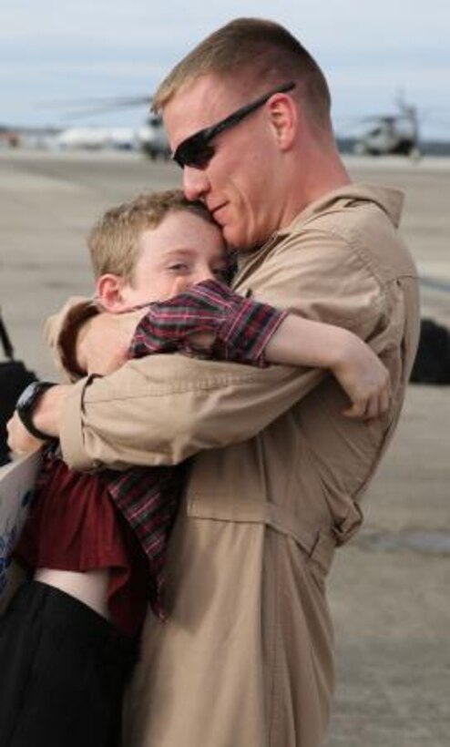 Capt. Jonathan Buckland reunites with his son Dec. 5 on Marine Corps Air Station Cherry Point's flight line after a nine-month deployment in support of the 26th Marine Expeditionary Unit and Special Purpose Marine Air-Ground Task Force Crisis Response Force. Buckland was the supply and logistics officer with Marine Aerial Refueler Transport Squadron 252 Detachment B while deployed.