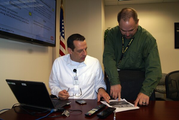 Bill Smiley, chief, Tulsa District Emergency Management and Security Office, and Geza Horvath, Tulsa District’s Operation Warfighter program manager, confer in the Emergency Operations Center.                  