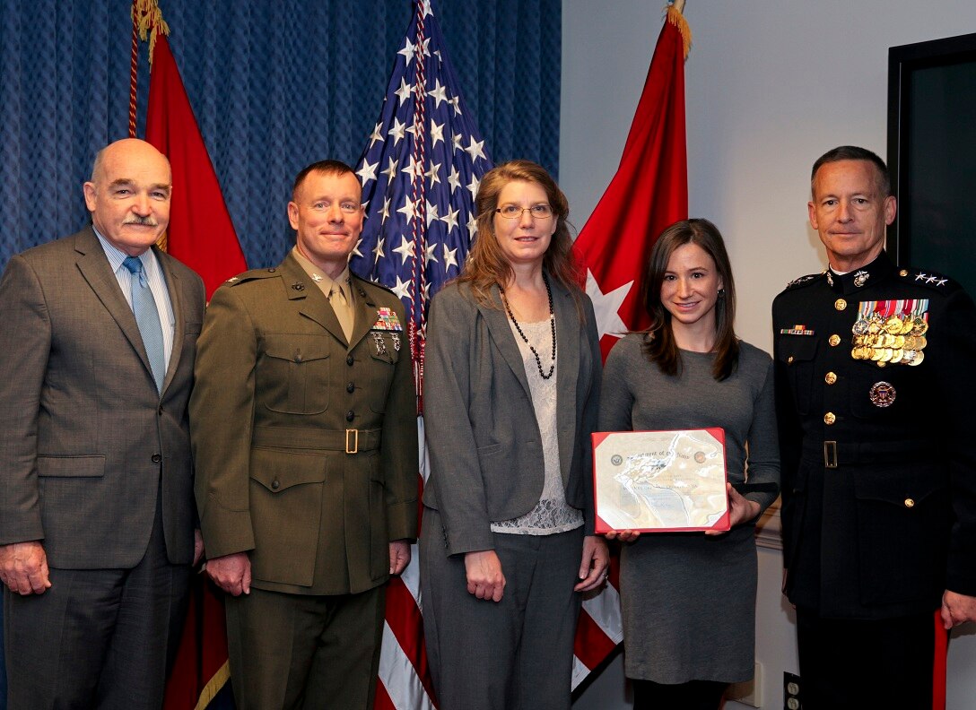 From left, Assistant Secretary of the Navy Dennis McGinn poses with Col. David Maxwell, commander of Marine Corps Base Quantico; Patty Greek, Quantico water and wastewater manager; and Stefanie Kivelin, the base energy manager as they receive the Secretary of the Navy’s Energy and Water Management Award from Lt. Gen. William Faulkner at the Pentagon on Nov. 6, 2013.