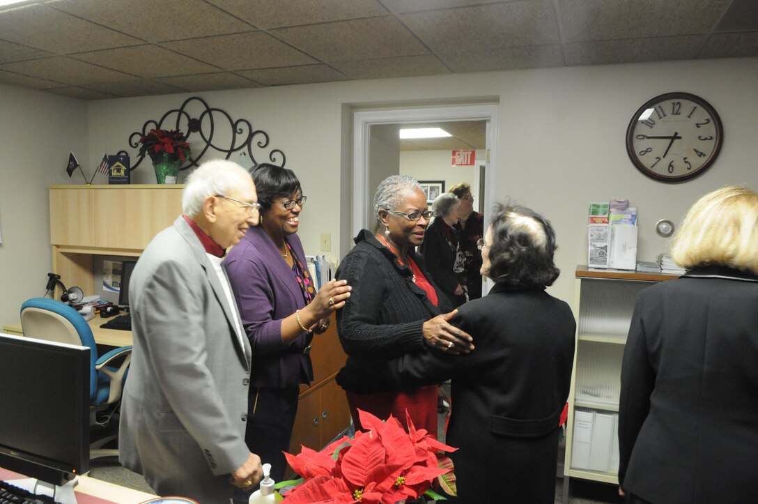 From left, former Quantico Mayor Mitchell Raftelis, Town Clerk Rita Frazier and Treasurer Debra Kidwell greet former Town Clerk Mary Booth at the open house for the new town office on Dec. 5. 