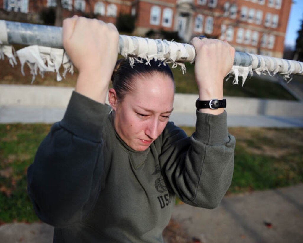 Sgt. Stephany Rector, administrative specialist, installation personnel administration center, Headquarters Company, Headquarters and Service Battalion, does pull-ups outside of her office, Dec. 3, 2012. 