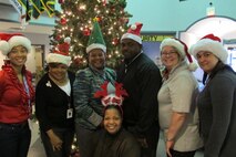 Members of Huntsville Center’s Installation Support and Programs Management Directorate’s Facilities Division wear festive holiday hats during Christmas Hat Day Dec. 10 at Huntsville Center. The team is celebrating “The 12 Days of Christmas” at the Huntsville Center Dec. 9-20 to reduce stress in the workplace this holiday season.