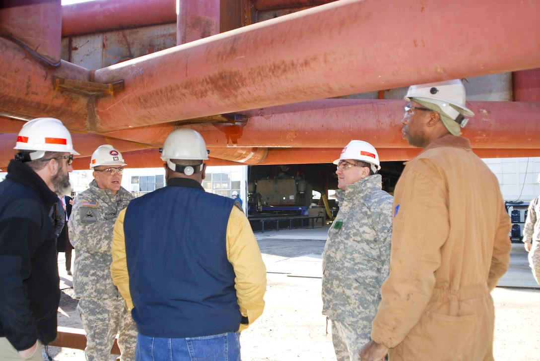 Terrence Brown (far right) explains the fabrication of the dredge Hurley ladder extension project to USACE Mississippi Valley Division Commander Brig. Gen. Pete DeLuca on his visit to USACE Memphis District’s Ensley Engineer Yard and Marine Maintenance Center Dec. 10. Left to right: Tim Marshall, Memphis District Commander Col. Jeff Anderson, Curtis Pigram, Gen. DeLuca and Terrence Brown. (USACE Photo/Brenda Beasley)