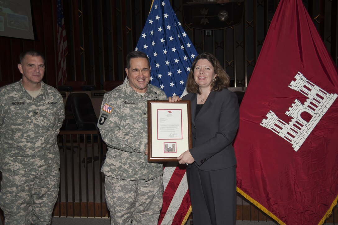 At a USACE Memphis District town hall meeting Dec. 11, USACE Mississippi Valley Division Commander Brig. Gen. Pete DeLuca presents a framed letter from the Chief of Engineers, Lt. Gen. Thomas Bostick, to Elizabeth Burks recognizing her completion of all requirements for the U.S. Army Lean Six Sigma Black Belt certification.  (USACE Photo/Brenda Beasley)